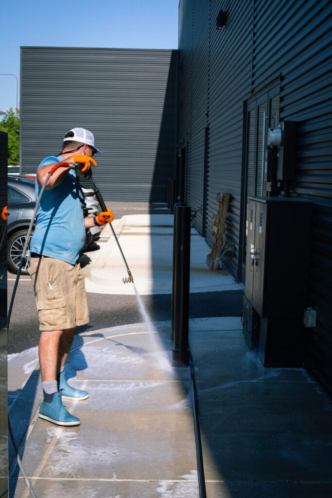 Professional commercial power washing service cleaning a building exterior
