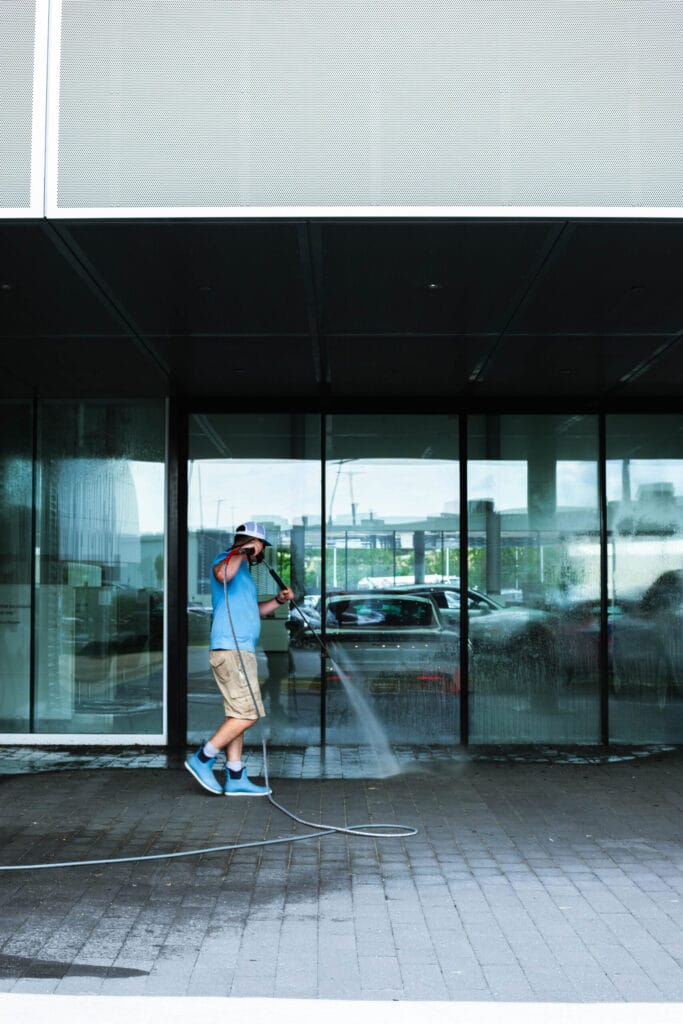 Keenwick team performing commercial power washing on building exterior