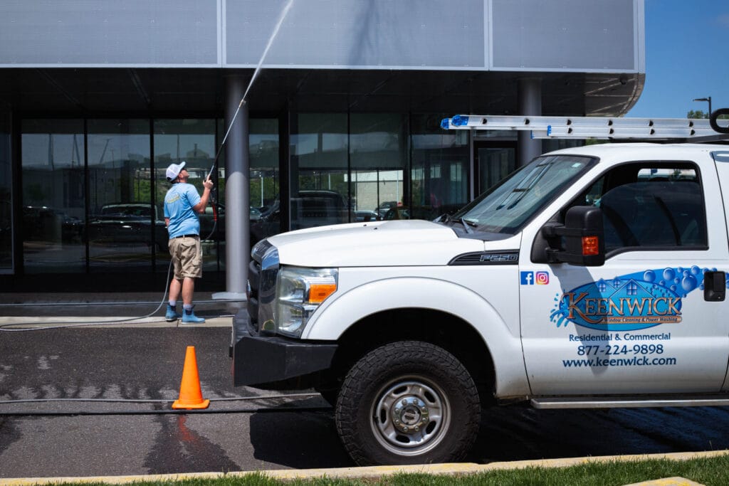 Keenwick team performing commercial window cleaning on a modern building exterior