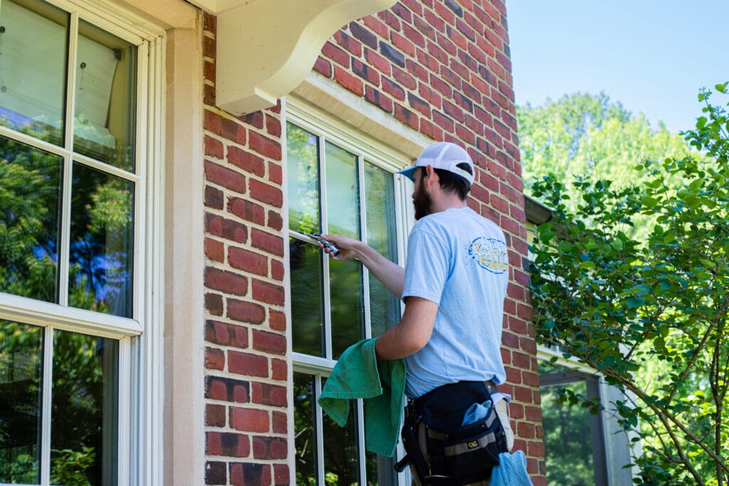 Professional residential window cleaning for a multi-story home exterior.