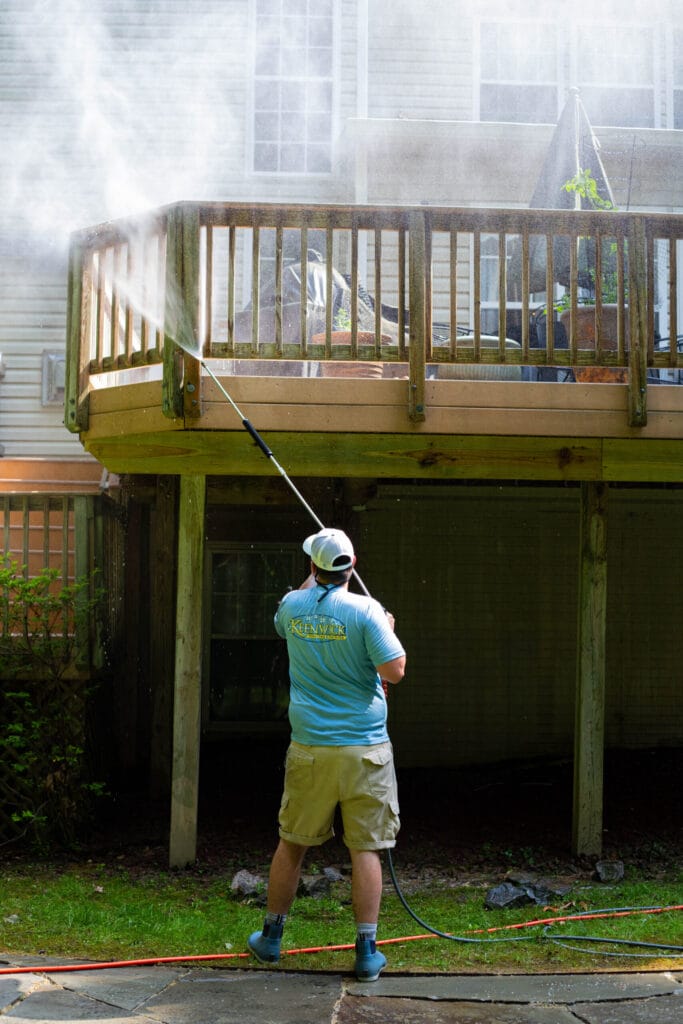 Keenwick team washing residential wood, vinyl, and metal fence
