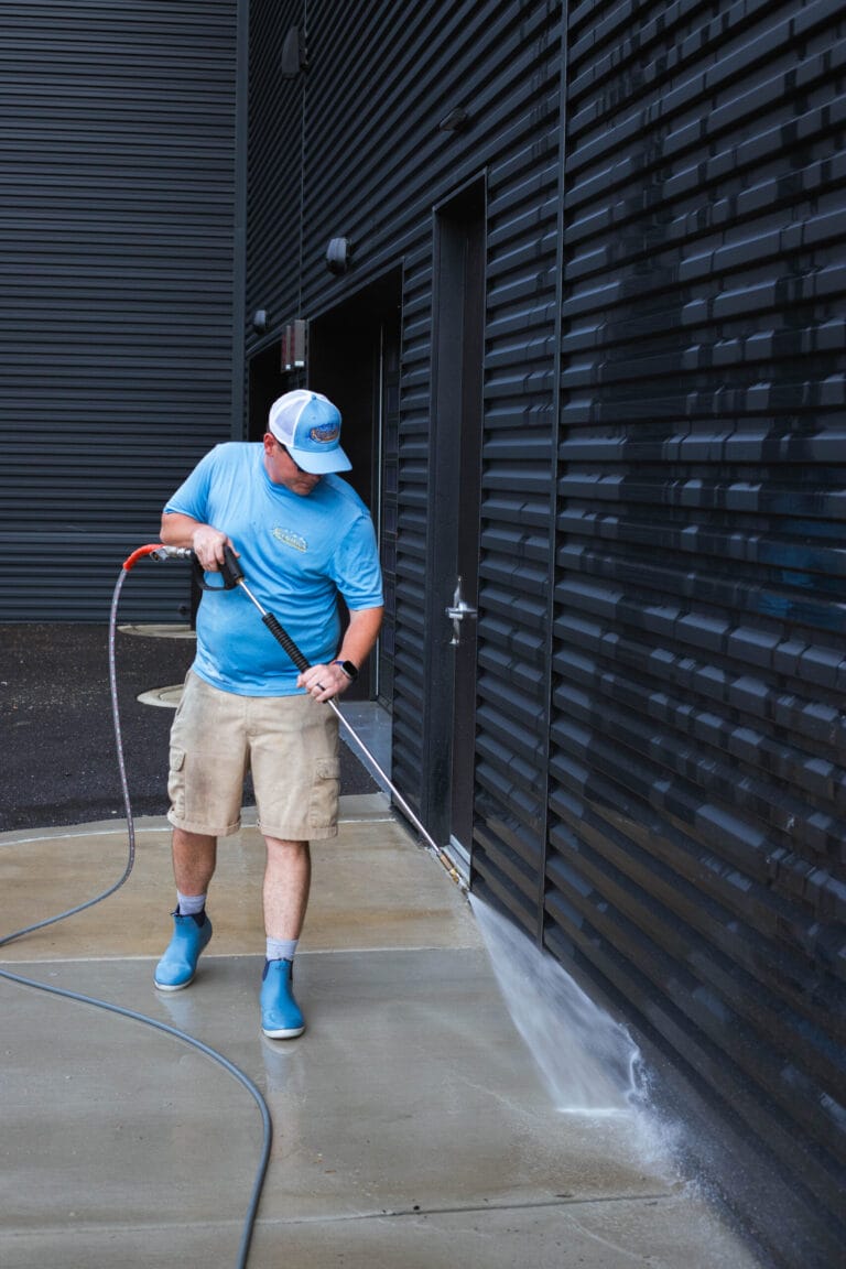 Commercial building exterior being professionally power washed.