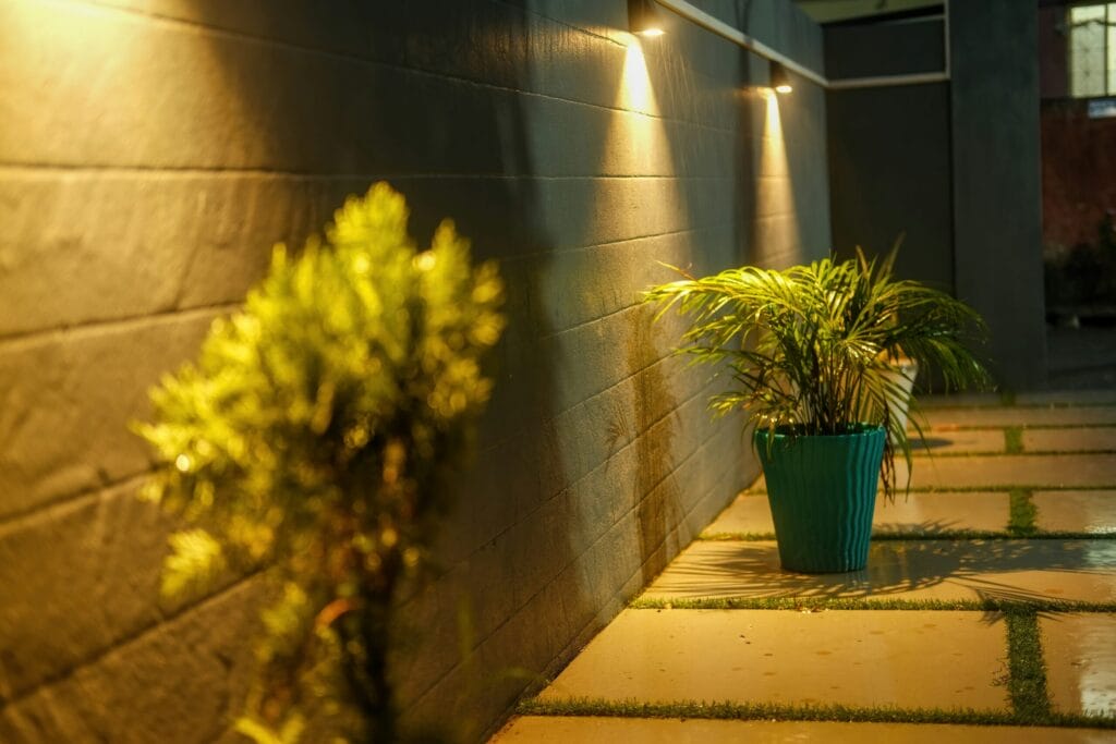 Recessed soffit lighting illuminating outdoor walkway and plants at Maryland home